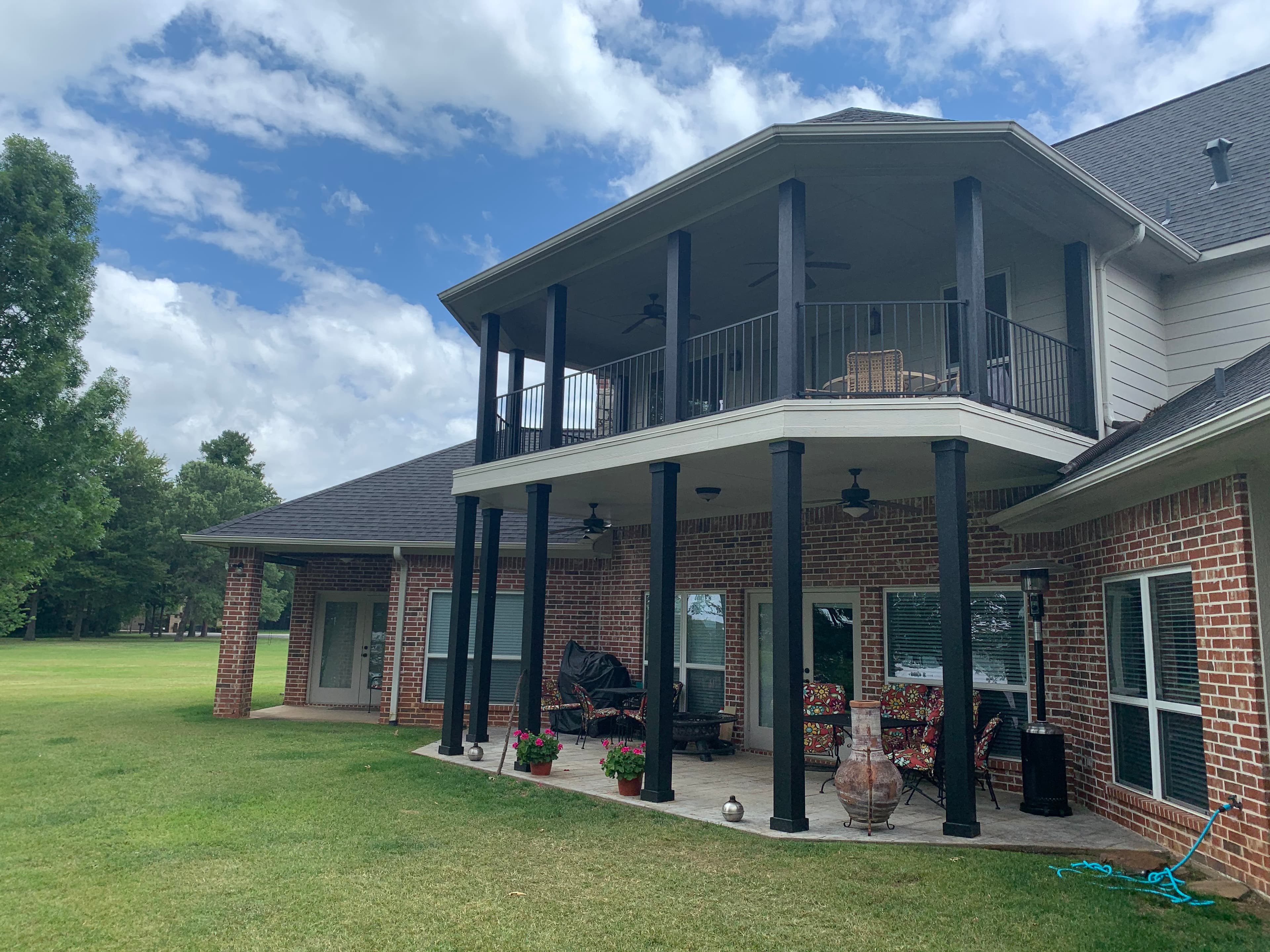 Another view of wrapped porch posts and iron railing