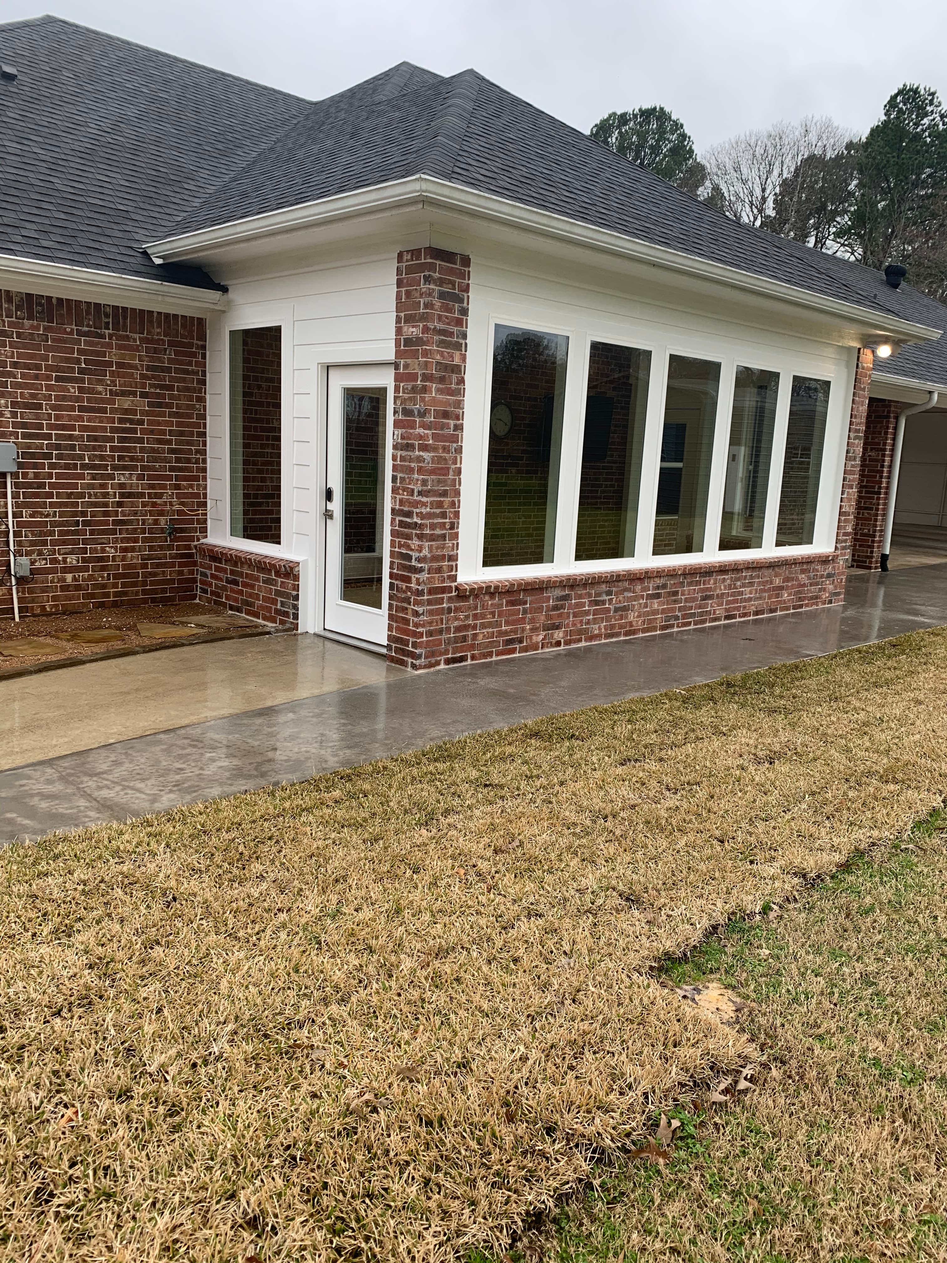 Another exterior view of enclosed back patio