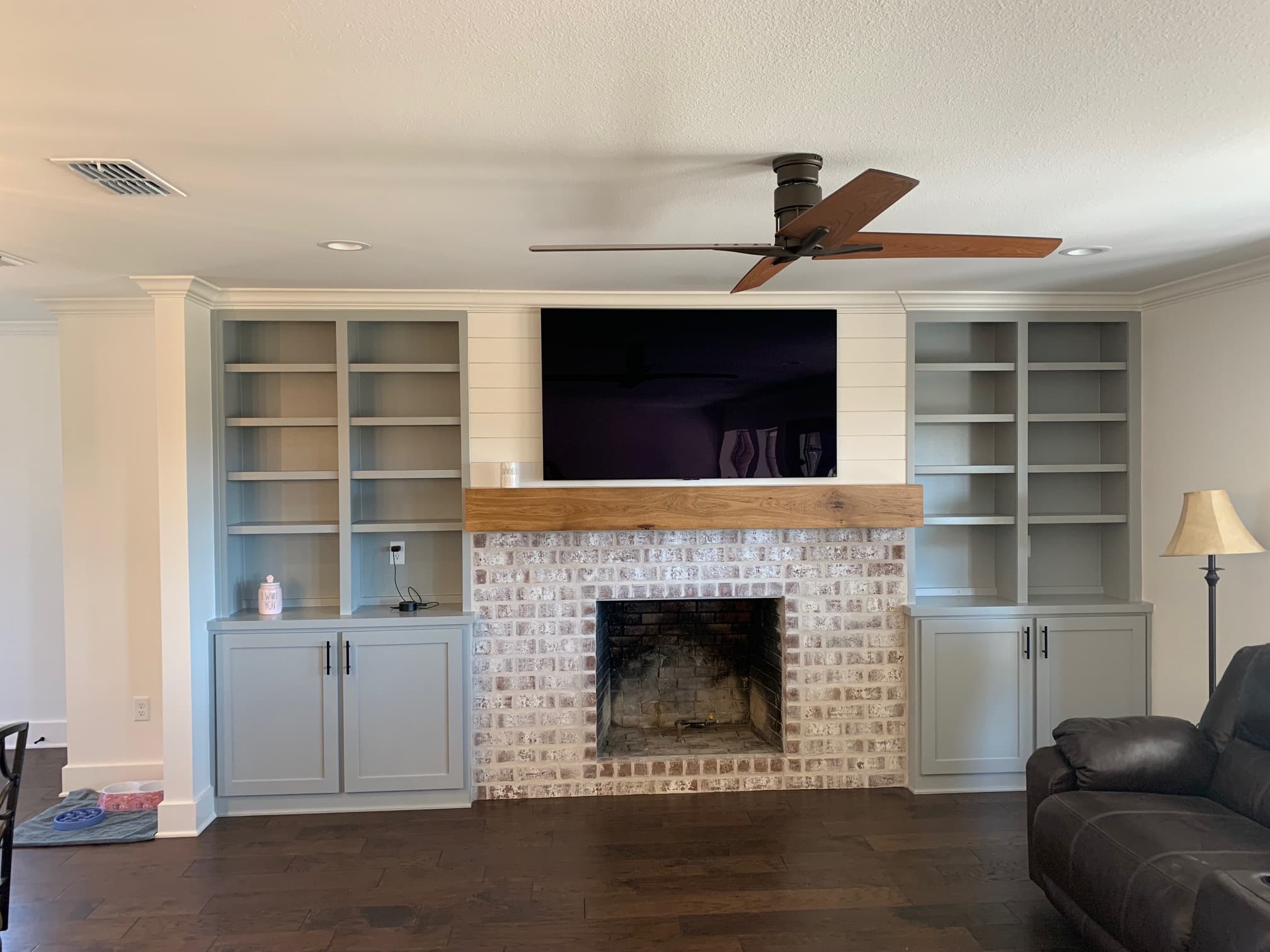 Remodeled fireplace and mantel with built-in bookshelves