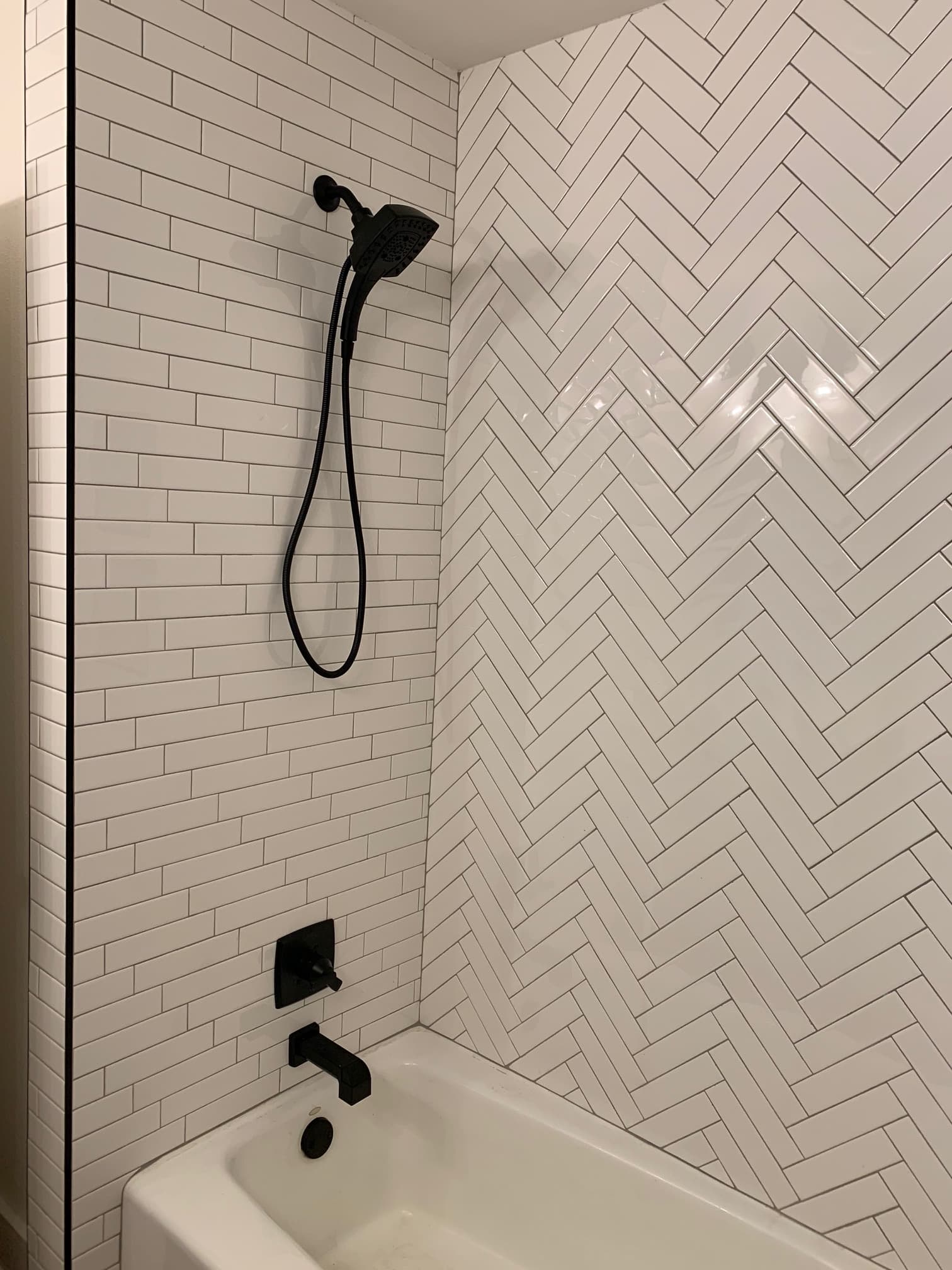 Remodeled bathroom with subway tile in various patterns