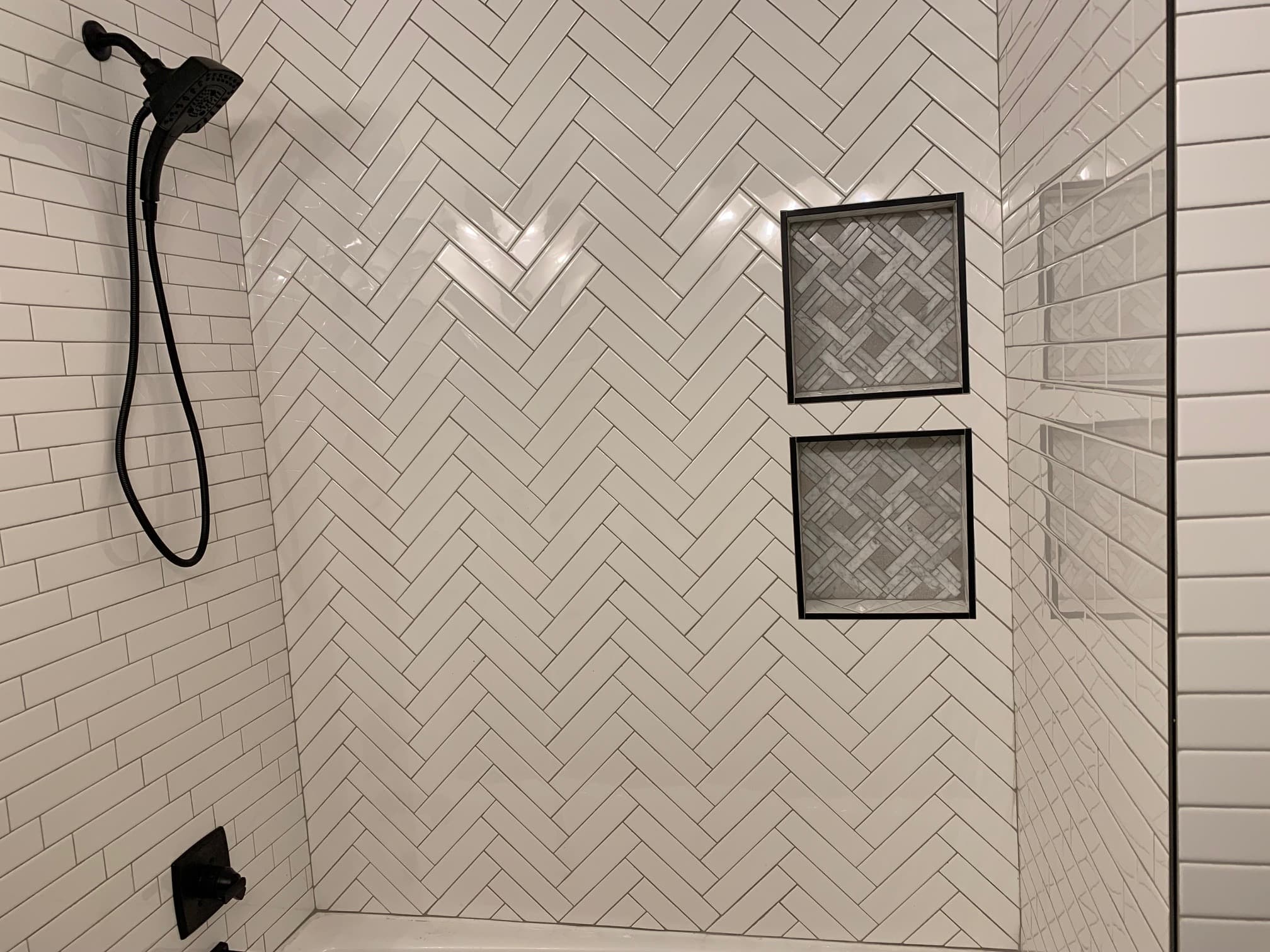 Remodeled bathroom with subway tile in various patterns