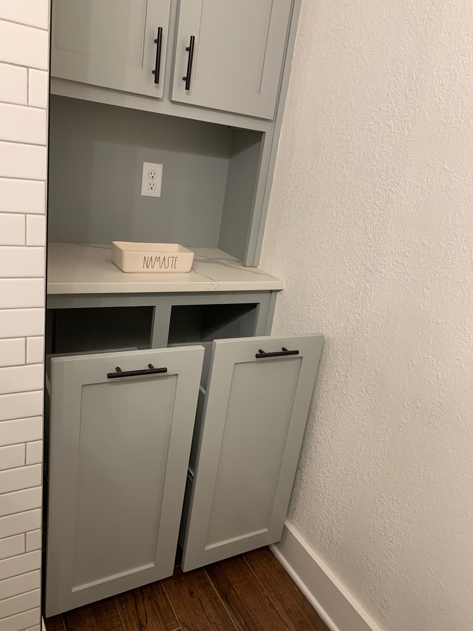 Remodeled bathroom with built-in laundry cabinet